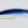 Close-up of a fishing fly with blue, black, and white materials.