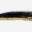 Close-up of a textured black and gold object on a white background.