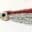 Close-up of a fishing lure with red and silver strands and a realistic eye.