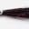 Close-up of a black and red fishing lure with glitter.