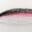 Close-up of a brush stroke blending white, pink, and black colors.
