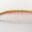 Close-up of a single eyebrow with green and pink hues.