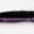 Close-up of a synthetic fishing lure with black and glittery purple colors.