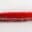 Close-up of a multicolored woven fabric edge with red threads extending.